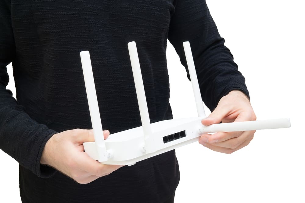 A man holding a Wi-Fi 6 router