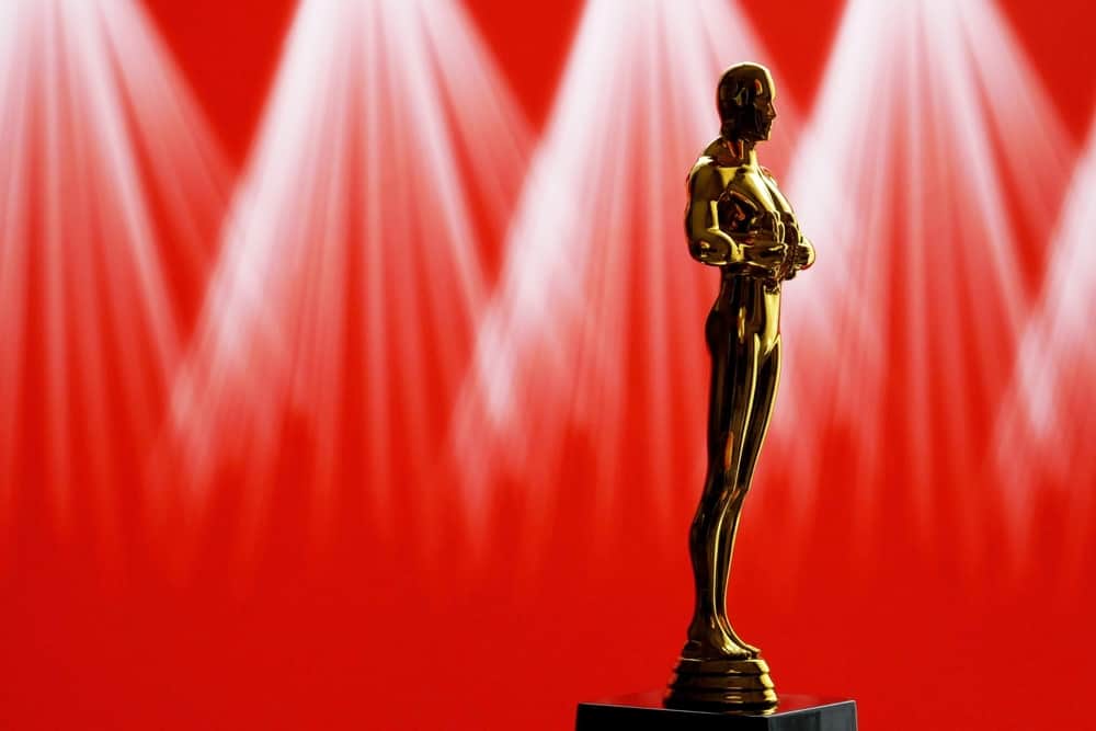 Academy Award trophy on red curtain background
