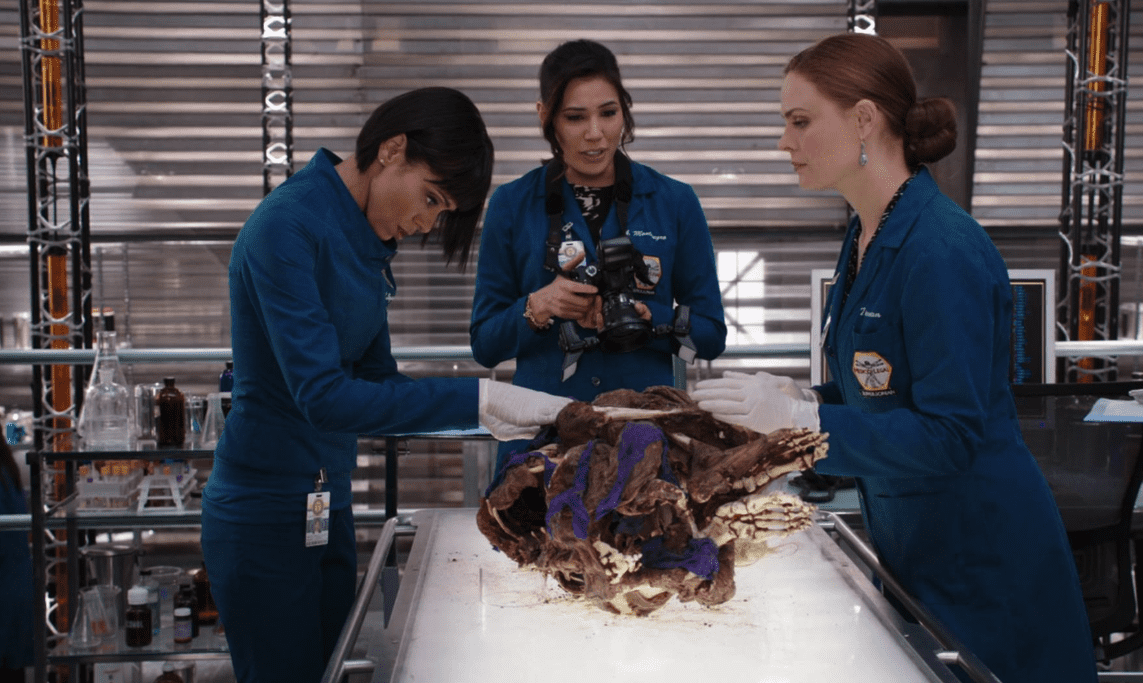 Camille, Angela, and Temperance discuss their findings at the lab